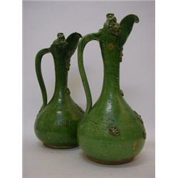A PAIR OF ART POTTERY EWERS, late 19th Century, mottled green glaze, applied snails and fluted di...
