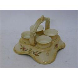 A CROWN DEVON EGG CUP AND STAND, for four, 'Eva' pattern, height 13cm  £30-40...