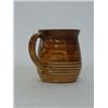 Image 1 : STUDIO OF BERNARD LEACH, a small jug, chocolate glazes, impressed mark to base of handle, height ...