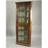 Image 1 : A George III mahogany corner cupboard, with an arched glazed door, over an associated lower se...