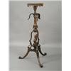 Image 1 : A reproduction carved mahogany torchere on a scrolled tripod base Est. 250/350...