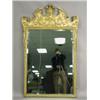Image 1 : A pair of gilt wall mirrors with Italianate moulded gesso decoration, each surmounted with a b...