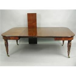 A George III mahogany extending dining table, with three leaves, having a moulded top, raised...