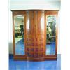 Image 1 : An Edwardian mahogany and inlaid mirror door wardrobe with central bowfront cupboard doors above...