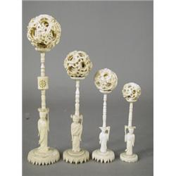 Four late 19th/early 20th century oriental carved ivory puzzle balls upon figural stands, tallest...