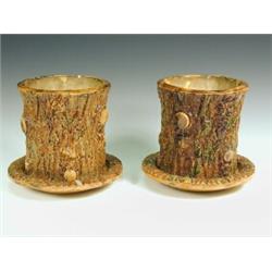 A pair of 19th century pottery bough pots and stands, naturalistically moulded as tree sections,...