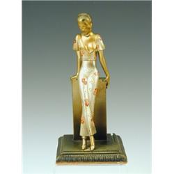 A painted spelter figure by Lorenzl in the form of a slender lady leaning on a pillar. A lamp bas...