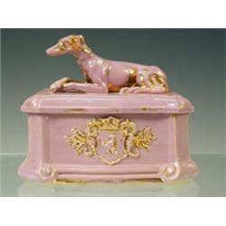 A late 19th century pottery box and cover with a greyhound finial and parcel gilt, 15cm high Est....
