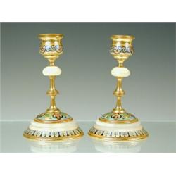 A pair of late 19th century French candlesticks in alabaster and bronze with champleve decoration...
