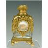 Image 1 : A French Palais Royale scent bottle with gilt metal mounts and circular architectural panels, 12c...