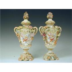 A pair of 19th century German porcelain vases and covers with applied and painted decoration (one...