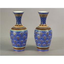 A pair of Mettlach stoneware vases, with blue grounds and stylised incised decoration, impressed...