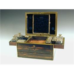 A mid 19th century coromandel and brass bound toilet box, with a fitted interior and unusual slid...
