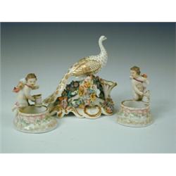 A pair of 19th century Berlin porcelain figural salts (A/F) and an early 20th century floral encr...