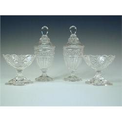 A pair of moulded and cut glass Regency style sweetmeat jars and covers and a pair of salts (A/F)...