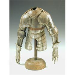 A miniature part suit of armour, on a wooden stand, 43cm high Est. 80/120...