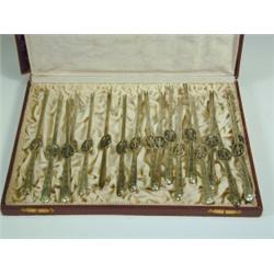 A set of eighteen German silver lobster picks with pierced and engraved decoration, marked 800, (...