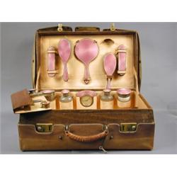 A crocodile skin dressing case, the fitted interior with enamel backed and silver items (some mis...