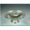 Image 1 : A silver basket of circular shape with a pierced border, swing handle and pedestal base, 1921, ap...