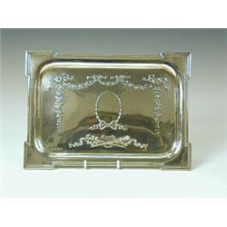 A George V silver dressing table tray, decorated with embossed floral swags, ribbon and two torch...