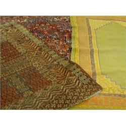Three rugs; a Bokhara and Persian design rug with a central radiating medallion; and a green grou...