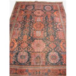 A large Persian rug, with a crimson and blue ground and central geometric patterns, 270 x 180cm (...