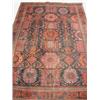 Image 1 : A large Persian rug, with a crimson and blue ground and central geometric patterns, 270 x 180cm (...