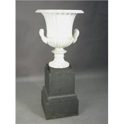 A pair of 19th century campana shaped cast iron urns on square plinths, each 136cm high Est. 1200...