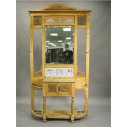 A late Victorian light oak hall stand, with a central bevel edged mirror above three printed tile...