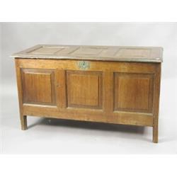 A 17th century oak coffer with a panelled top and front, (one leg repaired), 122cm wide Est. 300/...