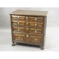 A 17th century chest of drawers, the four long drawers with geometric mouldings within applied bo...