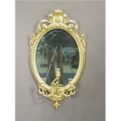 A pair of mid 19th century oval girandoles, with surmounted foliage, each with three sconces, (re...