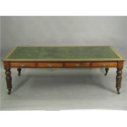 A Victorian mahogany library table, with four drawers either side, a central leather inset top an...