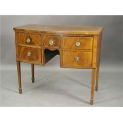 A Sheraton period inlaid mahogany bow fronted sideboard, of squat form with five drawers around a...