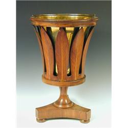An early 19th century mahogany oyster bucket, with a brass liner and fret cut leaf sides, on a tr...