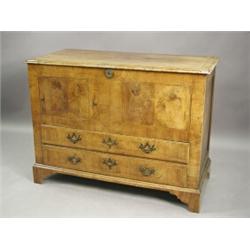 An 18th century walnut chest, the hinged crossbanded top over two base drawers, on bracket feet,...
