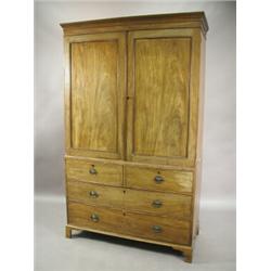 A Georgian mahogany press wardrobe, with a pair of panelled doors over two long drawers, 2.03m hi...