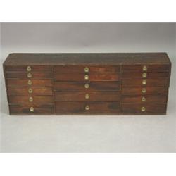 A mahogany watchmakers chest with an arrangement of seventeen drawers, with brass sunken handles,...