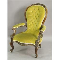 A Victorian walnut open arm chair with a carved and moulded show wood frame raised on scrolled fr...