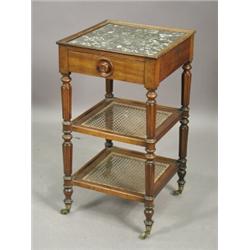 A Victorian mahogany marble top three tier bedside table with a single frieze drawer, with caned...
