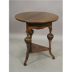 An Edwardian solid rosewood occasional table with a circular top on bulbous spirally turned legs...