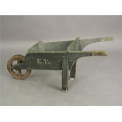 A painted pine miniature wheel barrow inscribed 'E.B.', 39cm high Est. 140/180...