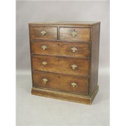 A George III mahogany chest of two short and three long drawers with a moulded caddy top on a pli...