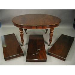 A Victorian mahogany extending dining table, with three leaves and a winding handle, on turned ga...