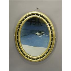 An Irish ebonised and parcel gilt oval wall mirror, the frame set with facet cut stones, (some da...