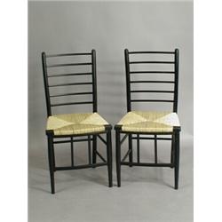 A pair of ebonised ladderback chairs, with rush seats Est. 160/200...