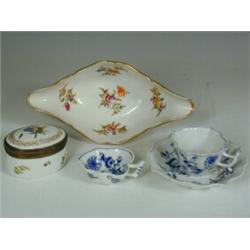 A Meissen blue and white pickle dish, with a handle and moulded leaf feet, (chip), a Meissen c...