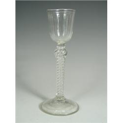 A George III wine glass with a bell shaped bowl and a cushion knop, with an opaque air twist s...