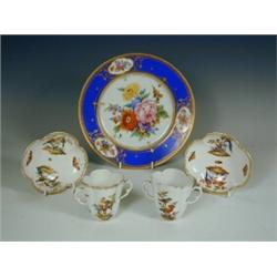 A Bavarian porcelain plate, decorated with coloured flowers, 25cm, and a pair of Dresden cups...