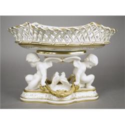 A 19th century Minton porcelain table centrepiece, modelled as a lozenge shaped basket support...